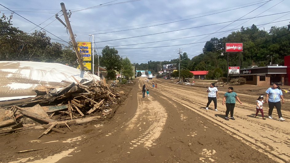 A street with debris pile on the left side.