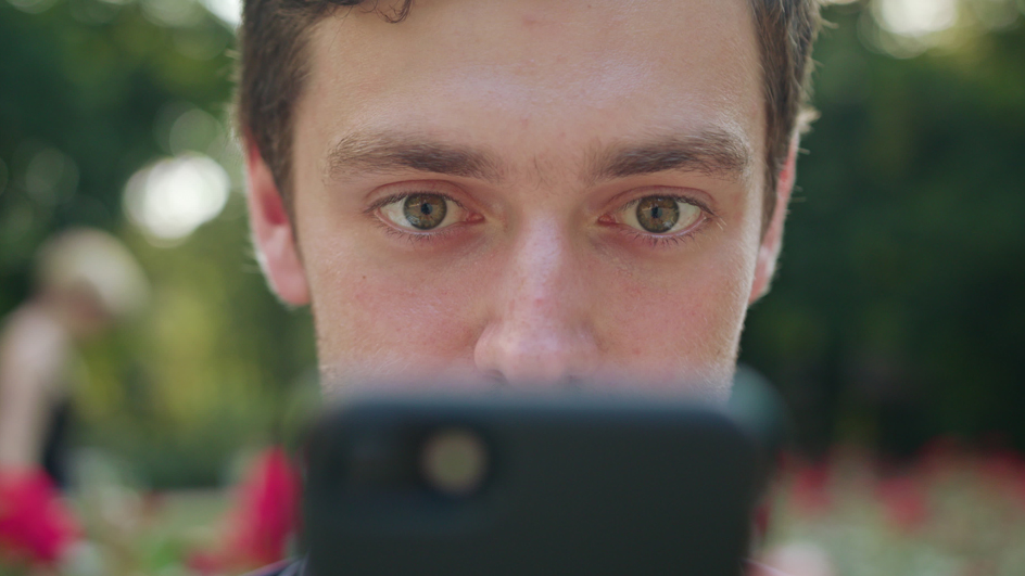 A man looks at his smartphone.