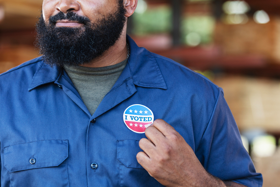 A man wearing an "I voted" sticker