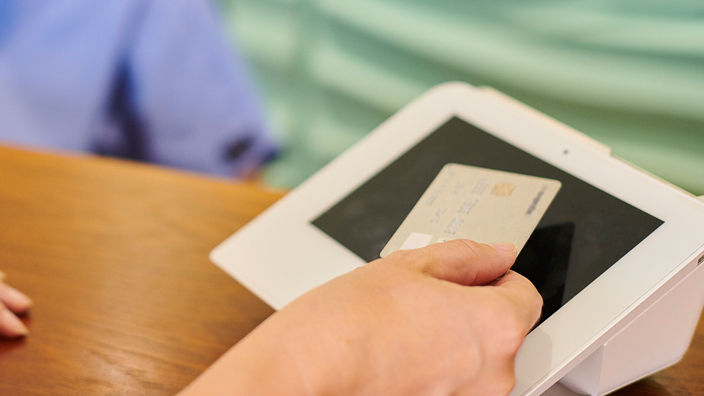 A patient makes a payment at a healthcare facility