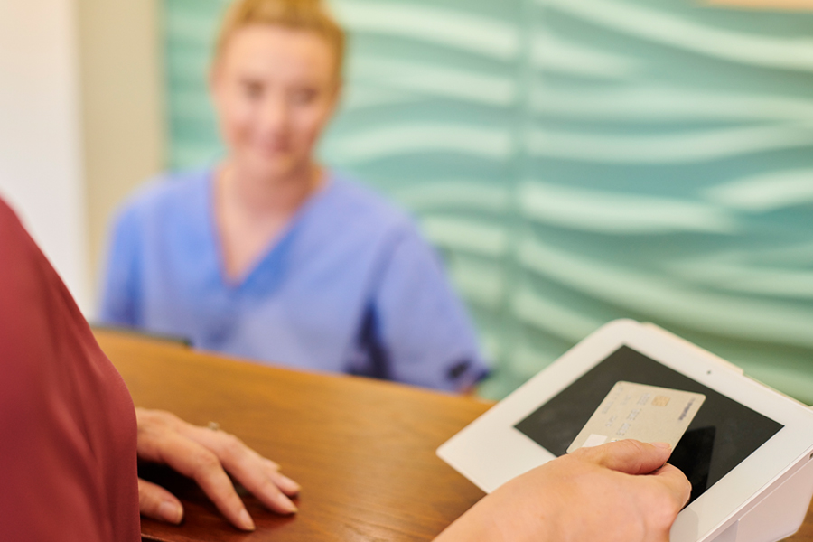 A patient makes a payment at a healthcare facility