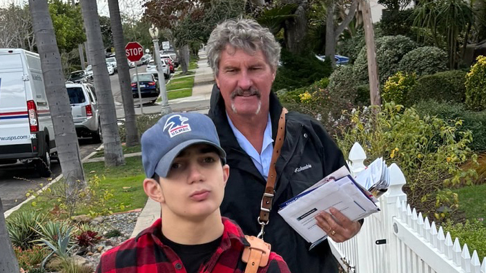 Gaylend “Zee” Zahn, a San Diego letter carrier, delivers mail with help from his friend, Roman Toriello.