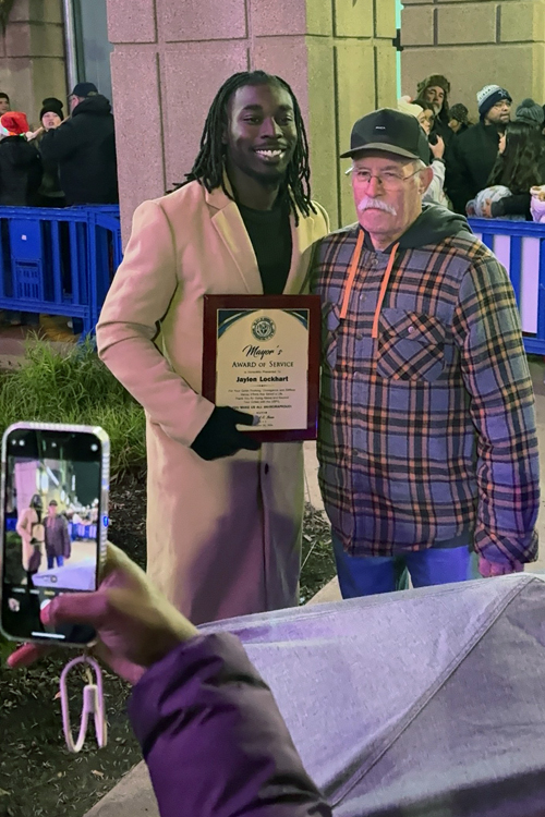 Jaylen Lockhart, left, and Guy Miller pose for a photo following the Christmas tree lighting ceremony.