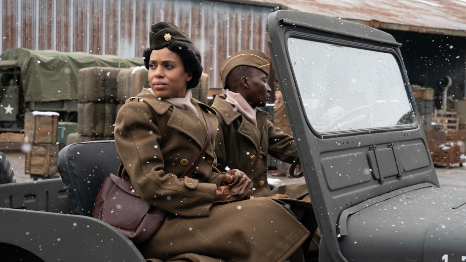 Actress Kerry Washington wearing a World War Two-era U.S. Army uniform and sitting in a Jeep