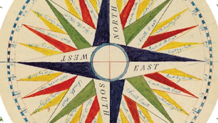 A round postage stamp displaying an illustration of a colorful compass