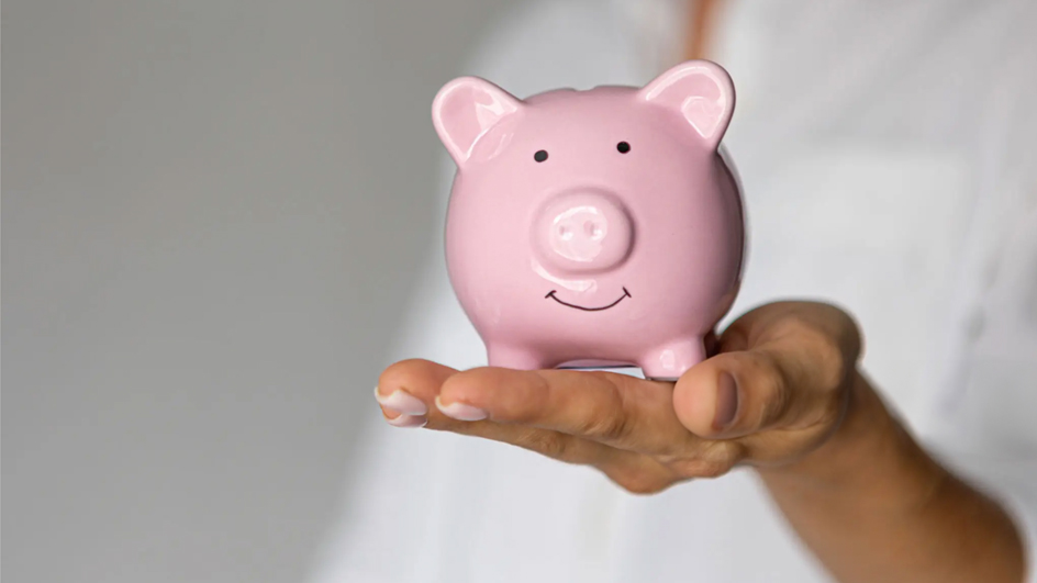 A woman’s hands hold a piggybank