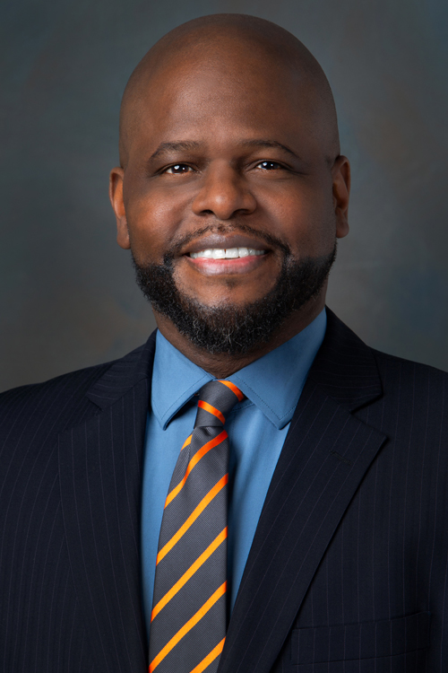 Studio portrait of a smiling man in a business suit and tie