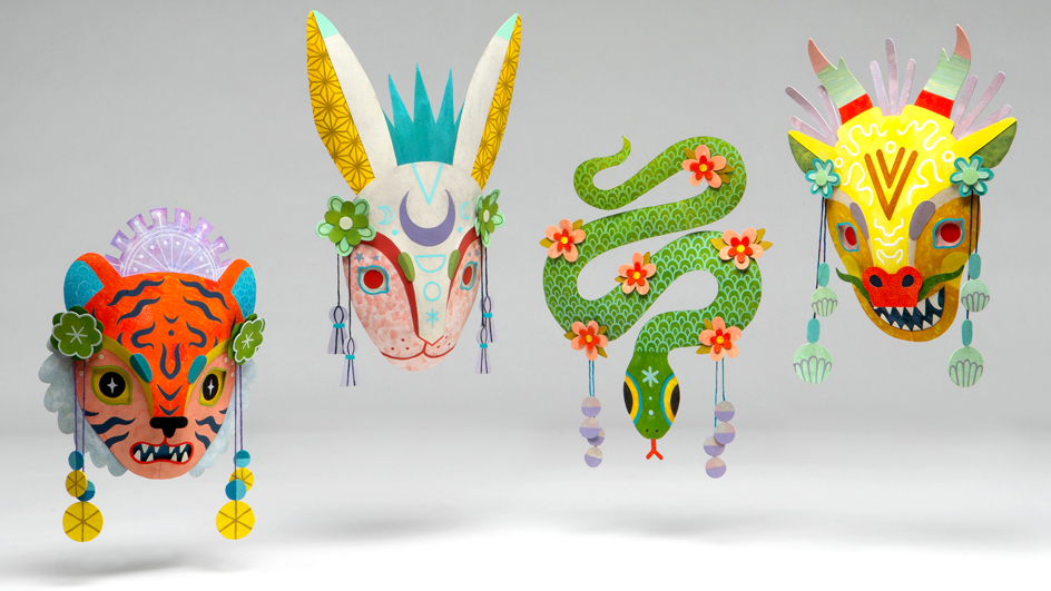 Four three-dimensional structures depicting the faces of a tiger, a rabbit and a dragon and a full-length snake are displayed against a gray background