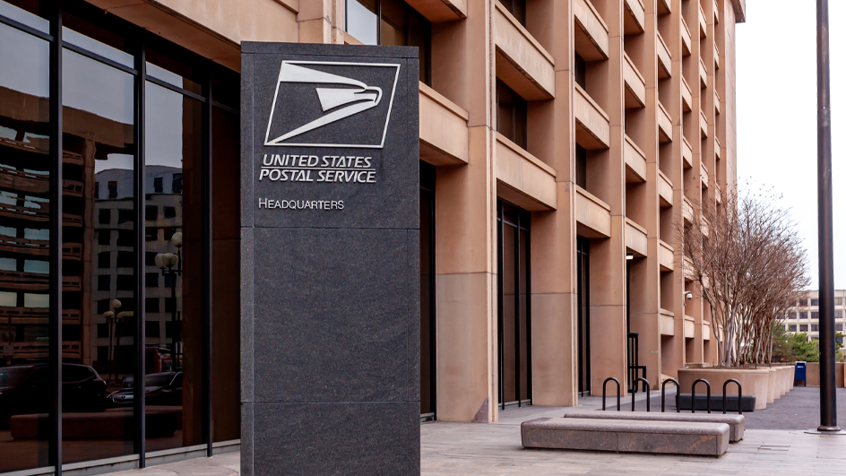 A shot of the entrance to a pink-hued office building featuring brutalist architecture