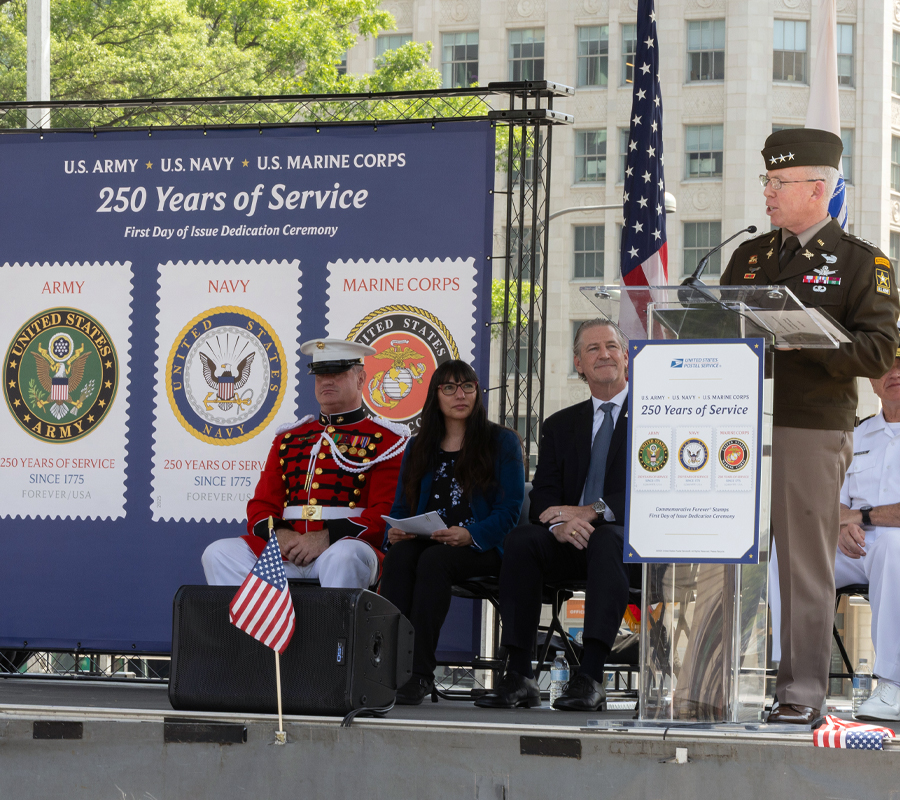 A man in an Army uniform speaks at a lectern