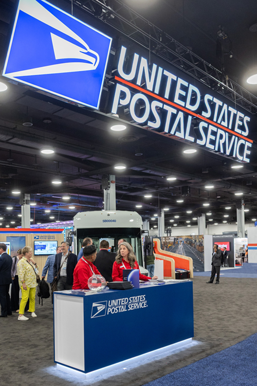 People mill around a conference center booth