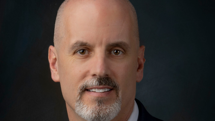 Studio portrait of a smiling man in a business suit and tie