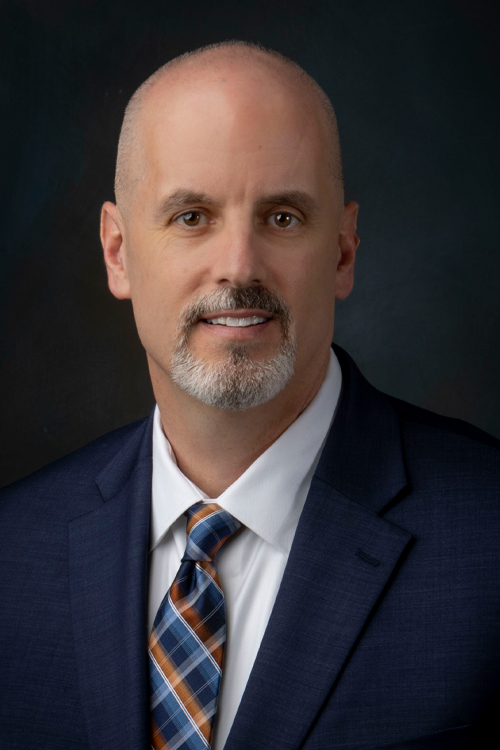 Studio portrait of a smiling man in a business suit and tie