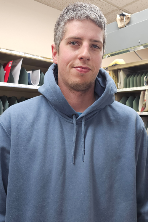 A man stands in a Post Office workroom