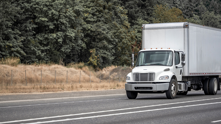 A white box truck on a road