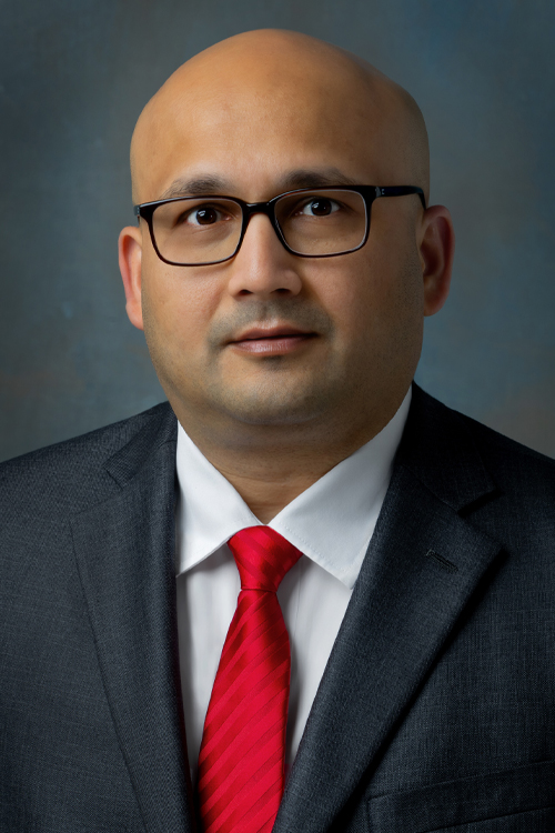 Studio portrait of a smiling man wearing a business suit