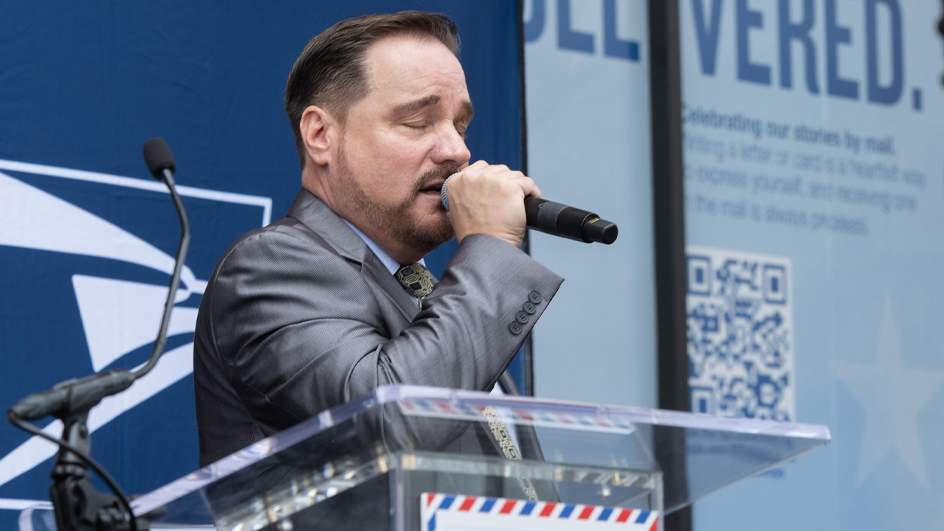 A man sings into a microphone