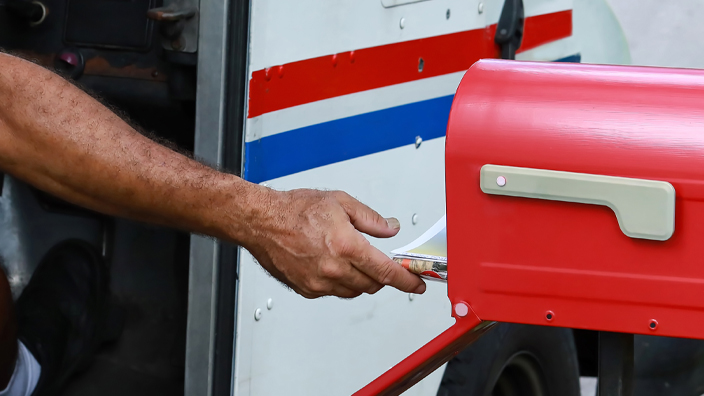 A USPS delivery vehicle on the road