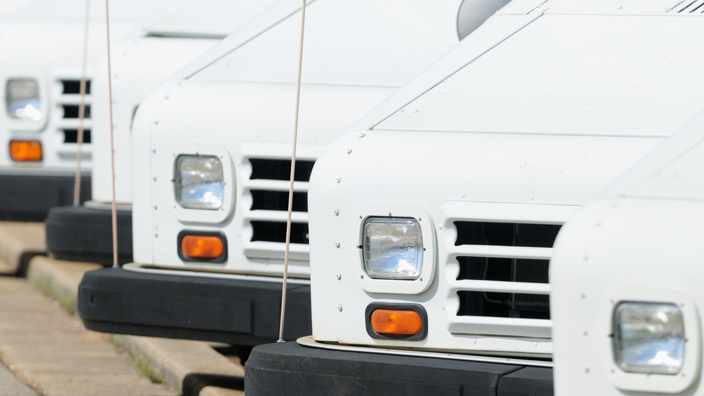 A row of mail delivery trucks