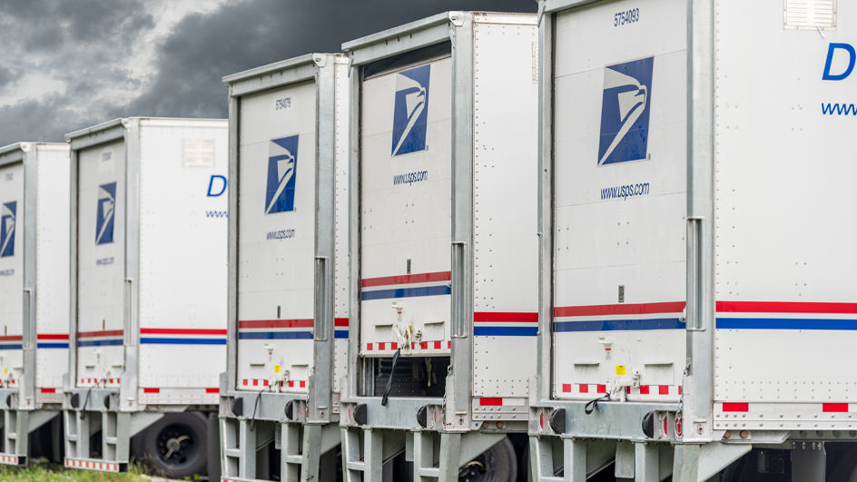 A row of USPS-branded trucks