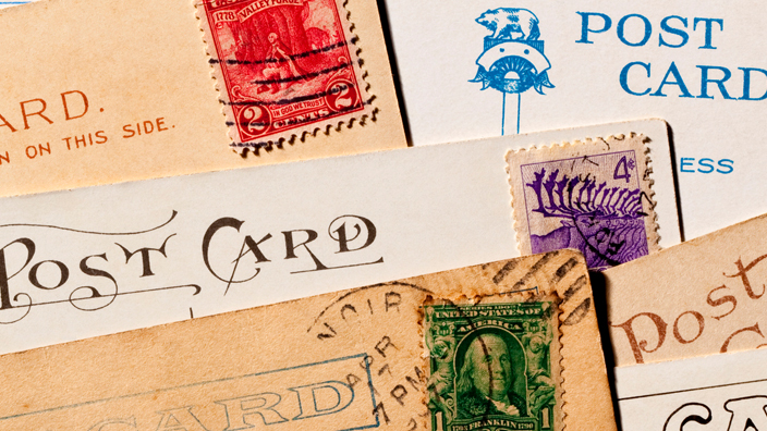 A collection of vintage postcards spread on a table
