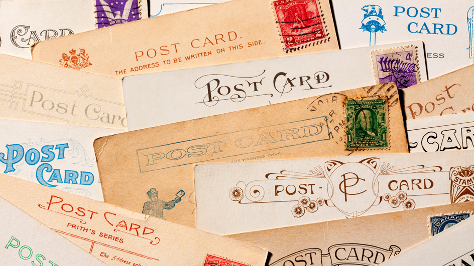 A collection of vintage postcards spread on a table