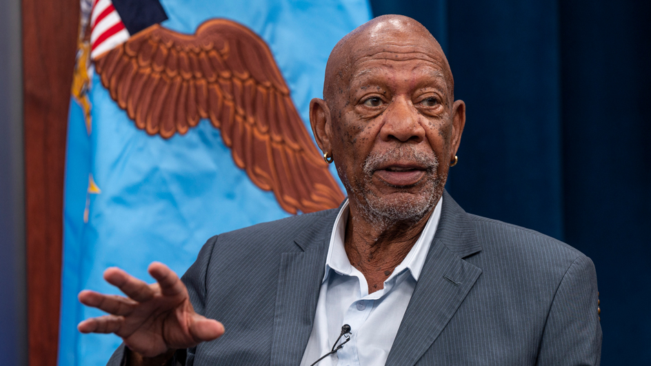 Morgan Freeman sits on a stage during a panel discussion