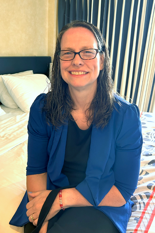A seated woman wearing a blue blazer