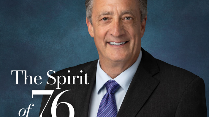 The cover page of the Eagle magazine showing a man in a dark suit and blue tie.