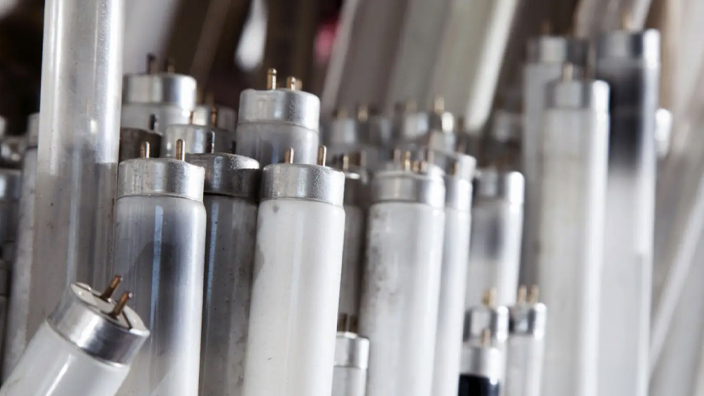 A stack of used fluorescent light bulbs