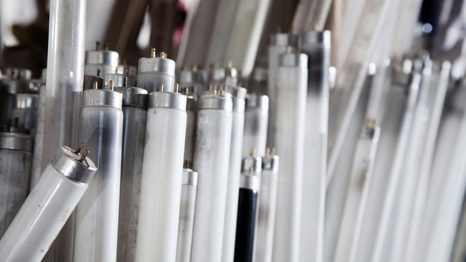 A stack of used fluorescent light bulbs