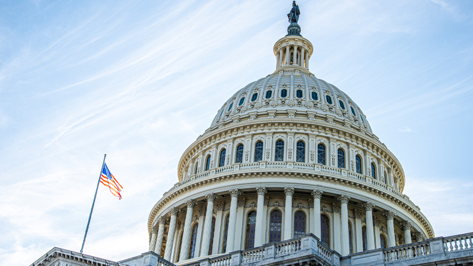 The dome of the U.S. Capitol with the U.S. flag flying nearby