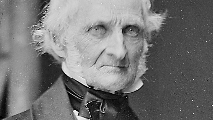 A black-and-white photograph of a man with white hair