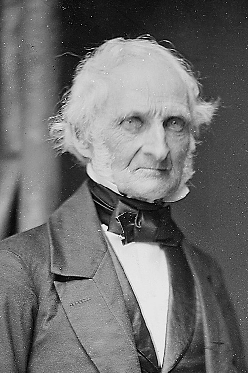 A black-and-white photograph of a man with white hair