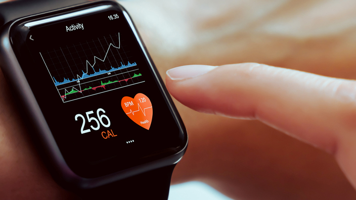 A smart watch displaying health information on a woman’s wrist