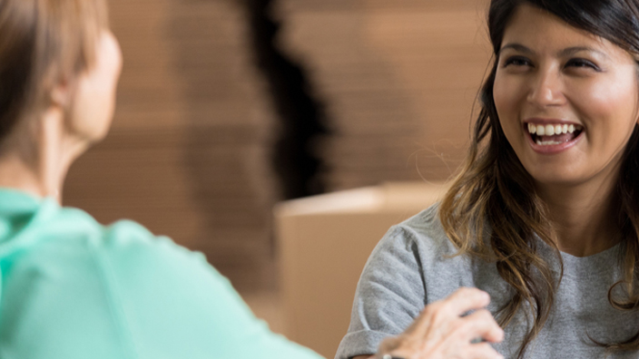 Smiling people collect donations during a food drive.