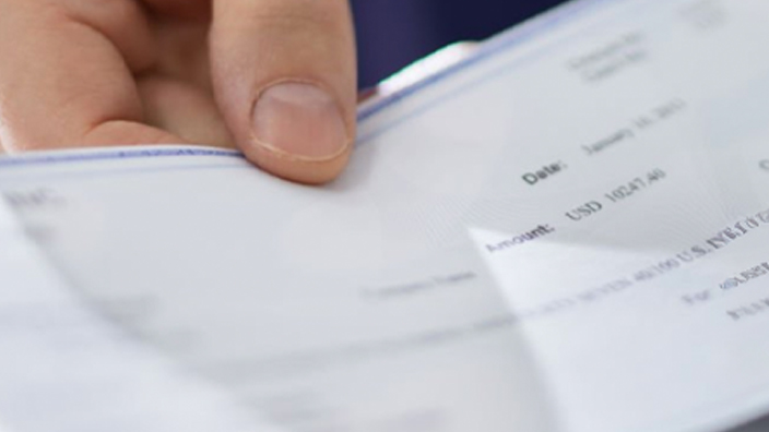 A calendar showing paycheck dates circled in red and holidays marked in black