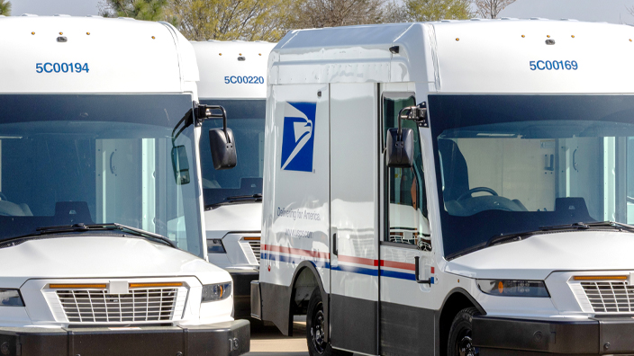A row of USPS delivery vehicles
