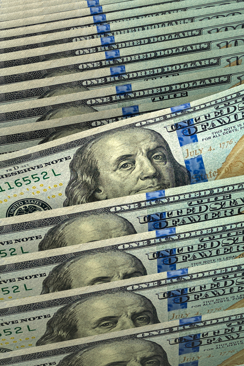 One-hundred-dollar bills laying on top of each other