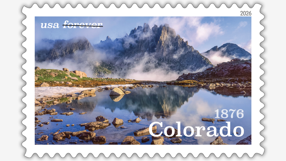 The Colorado Statehood stamp showing a photograph of a jagged mountain reflected in a natural pool of water.