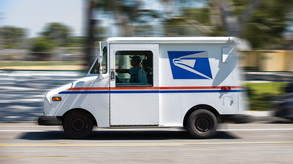 Profile of an LLV delivery vehicle driving down the road