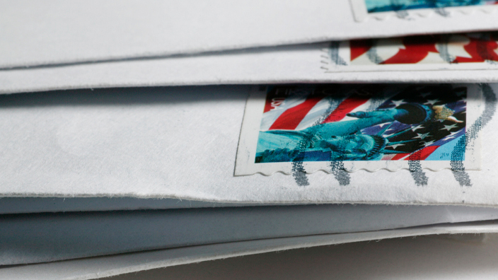 A close-up of a stack of envelopes