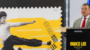Ben Kuo, senior vice president of facilities and infrastructure, serves as dedicating official for the Bruce Lee stamp at the first-day-of-issue ceremony in Seattle.