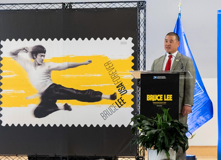 Ben Kuo, senior vice president of facilities and infrastructure, serves as dedicating official for the Bruce Lee stamp at the first-day-of-issue ceremony in Seattle.