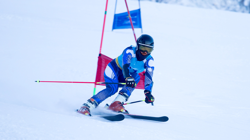 A downhill ski racer on a snowy mountain