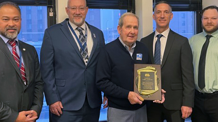 Five men standing beside one another at an award ceremony