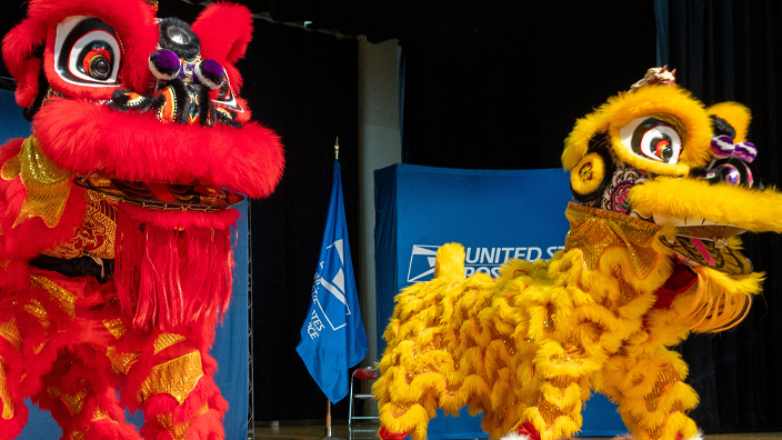 Performers costumed as a red and yellow dragon on stage