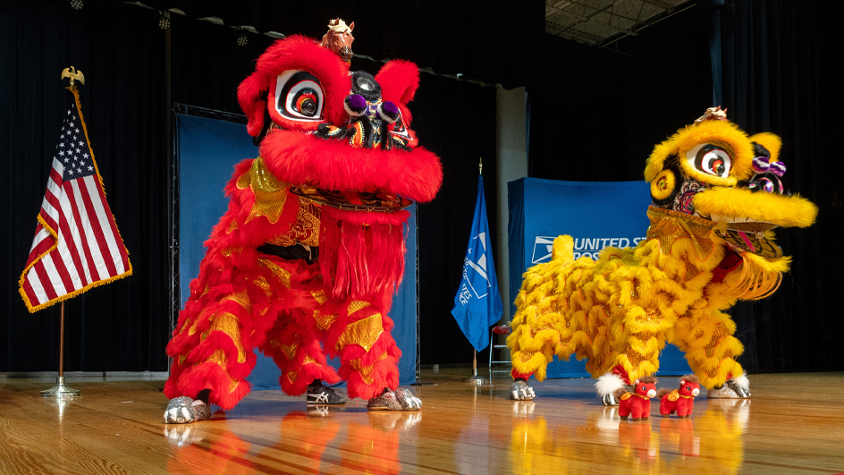 Performers costumed as a red and yellow dragon on stage