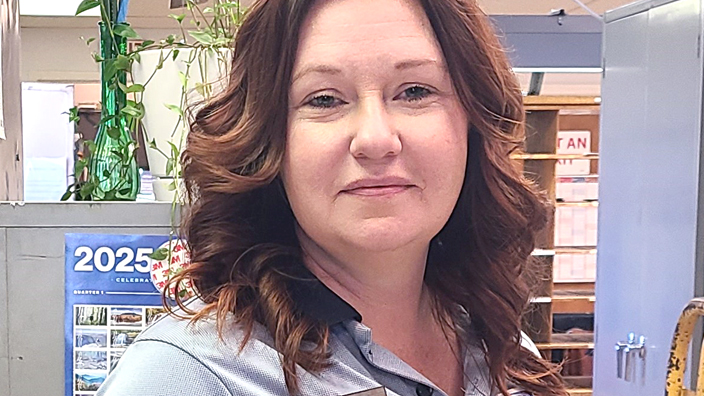 A woman wearing a blue polo shirt