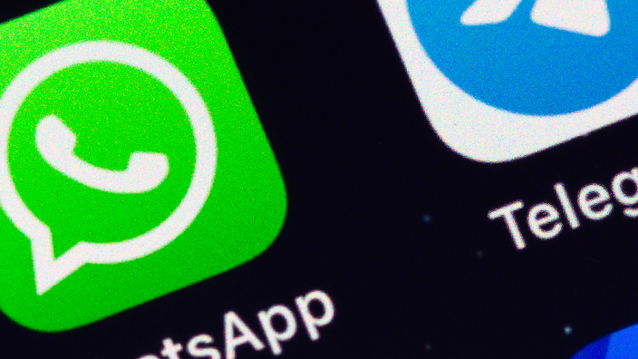 WhatsApp and Telegram app icons on display of an iPhone
